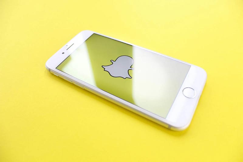 phone with snapchat logo ready to show snapchat ads for your business