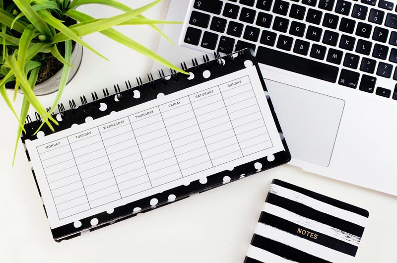 2021 weekly calendar and laptop ready for your business marketing check-up tasks