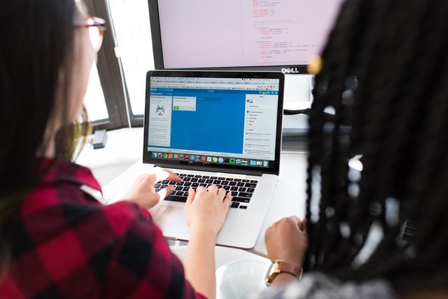 a web developer designing a website on a laptop